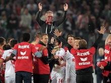 Kölns Trainer Peter Stöger wird von den Spielern auf den Schultern getragen. Foto: Marius Becker