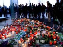 Trauernde stehen vor der Volkswagen Arena. Foto: Peter Steffen