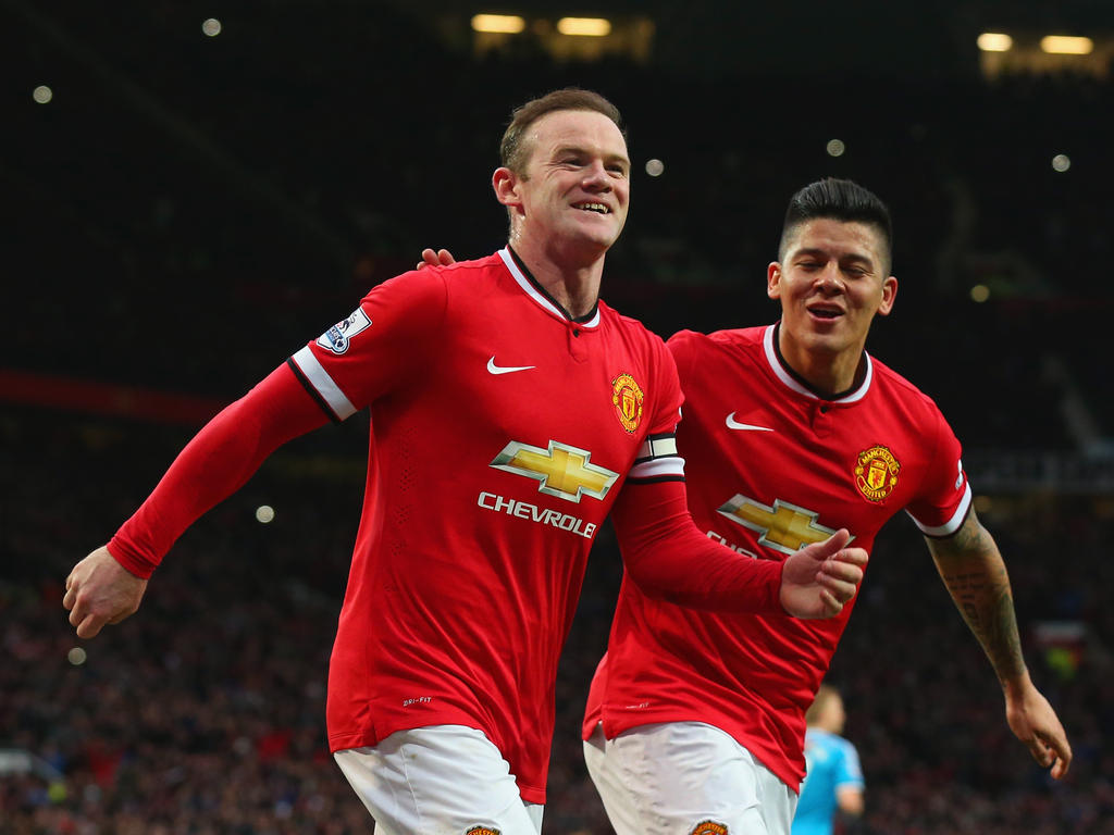 Rooney (izq.) celebra su primer tanto con Rojo. (Foto: Getty)