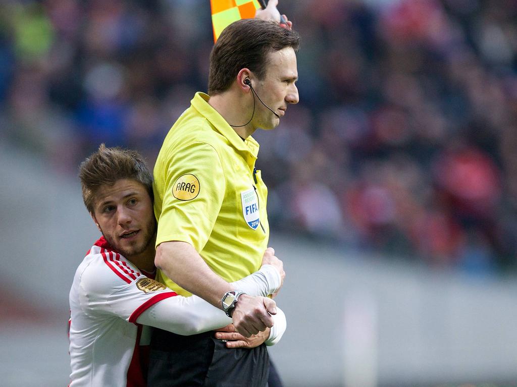 Lasse Schøne (l.) knuffelt grensrechter Bas van Dongen tijdens Ajax - sc Heerenveen. Voetbal.com Foto van de Week.