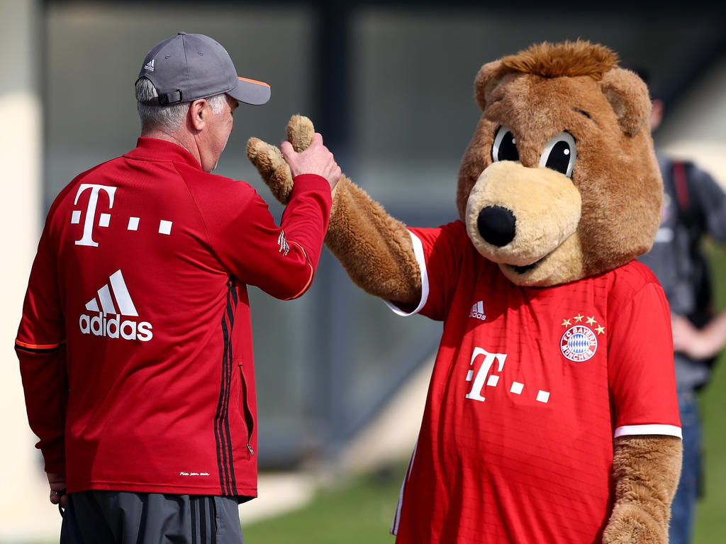 Bayern-Trainer Carlo Ancelotti (l.) klatscht das Maskottchen des Rekordmeisters ab