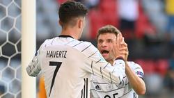 Kai Havertz (l.) und Robin Gosens sind beeindruckt von Thomas Müller (r.)