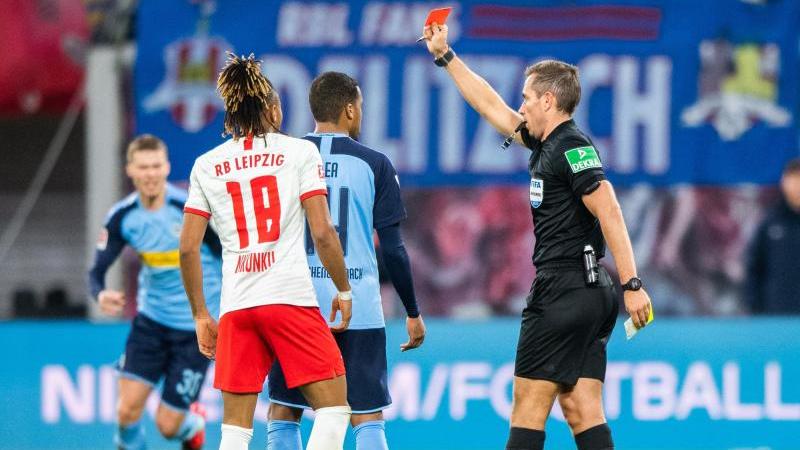 Schiedsrichter Tobias Stieler zeigt Mönchengladbachs Alassane Pléa (M.) die Gelb-Rote Karte