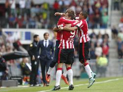Marcel Ritzmaier (l.) en Adam Maher (r.) bespringen doelpuntenmaker Luuk de Jong (m.) tijdens PSV Eindhoven - SC Cambuur. (21-09-2014)