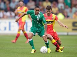 Tjaronn Chery (l.) en Erik Falkenburg (r.) vechten om de bal tijdens Go Ahead Eagles - FC Groningen. (25-8-2013)
