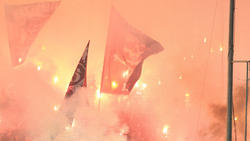 PAOK fans light flares during a soccer match between PAOK and Olympiacos.