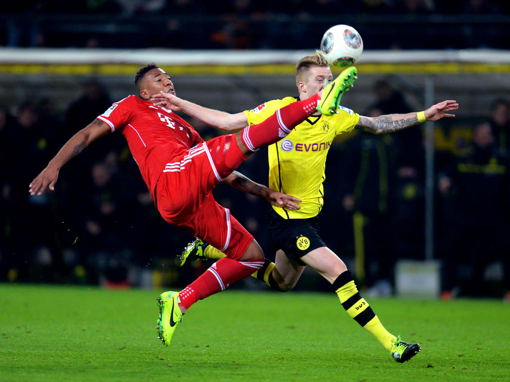 ...klärt Bayern Münchens Jerome Boateng gegen Borussia Dortmunds Marco Reus (r.) am 13. Spieltag der Bundesliga-Saison 2013/2014 und verhindert damit eine Großchance für die Schwarz-Gelben (23.11.2013).
