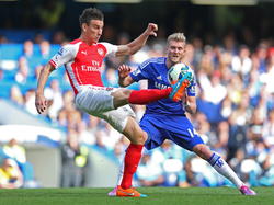 André Schürrle (r.) zet druk op Laurent Koscielny (l.) tijdens het competitieduel Chelsea - Arsenal. (05-10-2014)