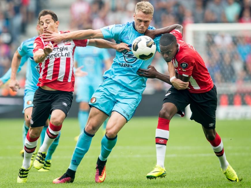 Nicolai Jørgensen (m.) houdt zich tijdens de wedstrijd PSV - Feyenoord staande tussen Andrés Guardado en Nicolas Isimat-Mirin. (18-09-2016)