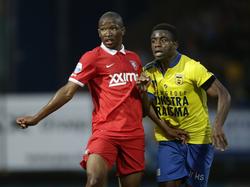 Kamohelo Mokotjo (l.) probeert Bartholomew Ogbeche (r.) van zich af te houden tijdens SC Cambuur - FC Twente. (9-8-2014)
