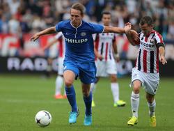Luuk de Jong (l.) probeert Robbie Haemhouts (r.) van zich af te houden tijdens Willem II - PSV Eindhoven. (10-8-2014)
