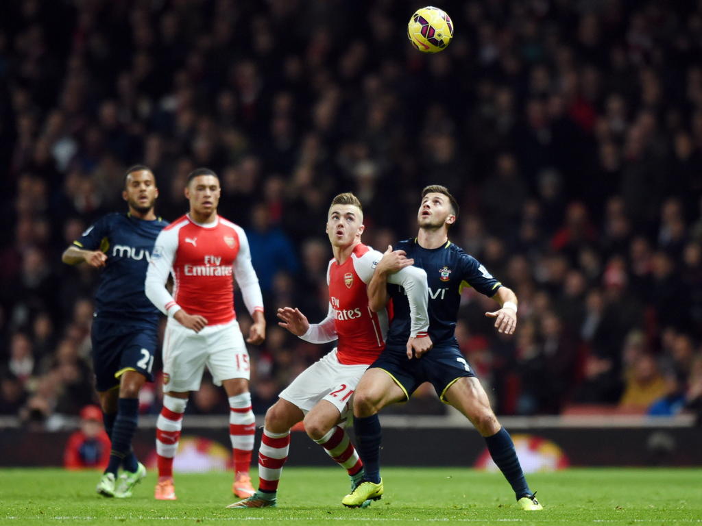 Op de voorgrond duelleren Calum Chambers (l.) van Arsenal en Southampton-speler Shane Long om de bal. (03-12-2014)
