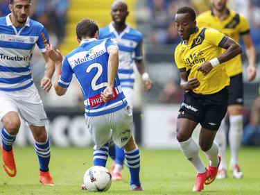 Elson Hooi (r.) speelt de bal tussen de benen van Bram van Polen (m.) door tijdens het duel NAC Breda - PEC Zwolle. (31-08-2014)