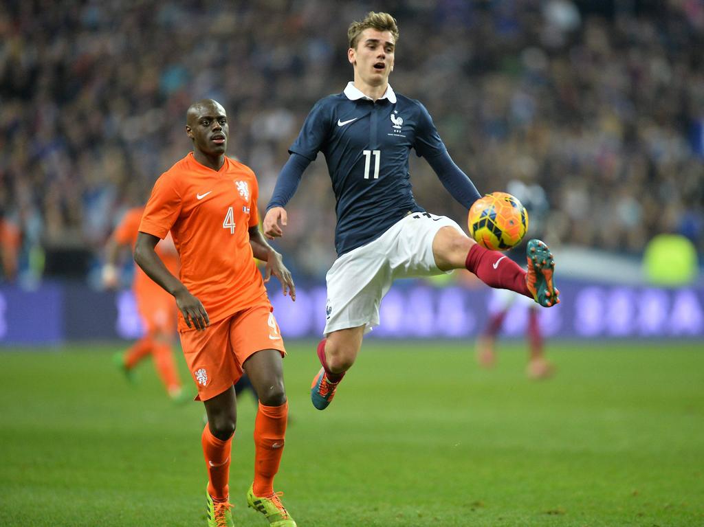 Bruno Martins Indi (l.) kijkt toe hoe Antoine Griezmann (r.) de bal aanneemt tijdens Frankrijk - Nederland. (5-3-2014)