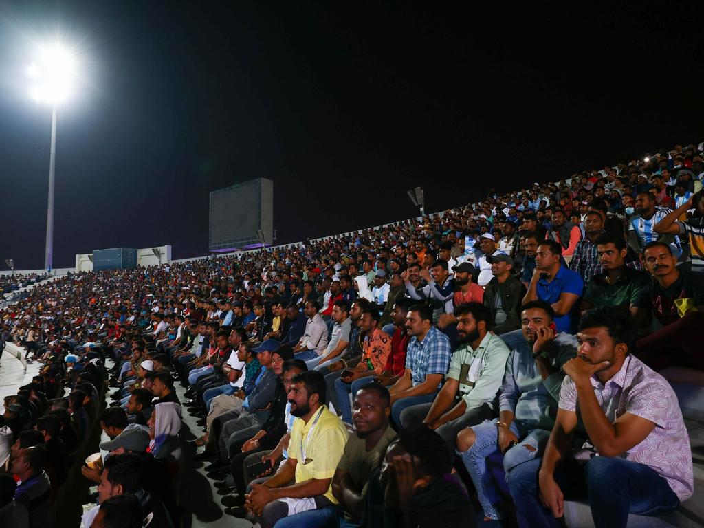 Arbeiter, überwiegend aus Indien, Bangladesch, Nepal und anderen ärmeren Ländern Asiens, verfolgen ein WM-Spiel auf einer Großbildleinwand