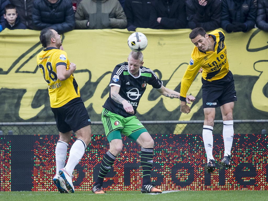 De NAC Breda-spelers Kenny van der Weg (l.) en Uros Matic (r.) komen te laat om Feyenoord Lex Immers (m.) het koppen te beletten. (21-12-2014) De NAC Breda-spelers Kenny van der Weg (l.) en Uros Matic (r.) komen te laat om Feyenoord Lex Immers (m.) het koppen te beletten. (21-12-2014)