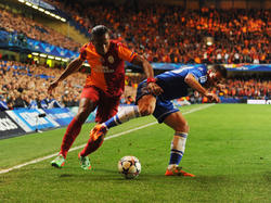 Didier Drogba (l) passeert Azpilicueta (r) in het Champions League-duel tussen Chelsea en Galatasaray. (18-3-2014)
