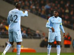 Yaya Toure geeft Kolo Toure aanwijzingen in een wedstrijd van hun club Manchester City. (15-03-12)