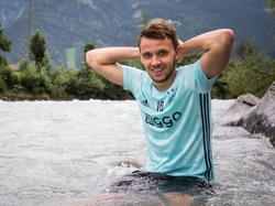 Robert Murić koelt ontspannen af in een Oostenrijkse beek na een training van Ajax. (08-07-2016)
