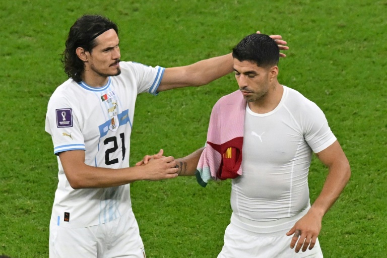 Uruguay stars Edinson Cavani (left) and Luis Suarez cut frustrated figures after their 2-0 defeat to Portugal