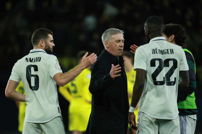 Real Madrid's Italian coach Carlo Ancelotti (C) greets his players after their stunning cup comeback against Villarreal