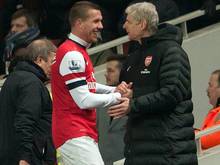 Podolski soll laut Wenger (r.) bei Arsenal bleiben
